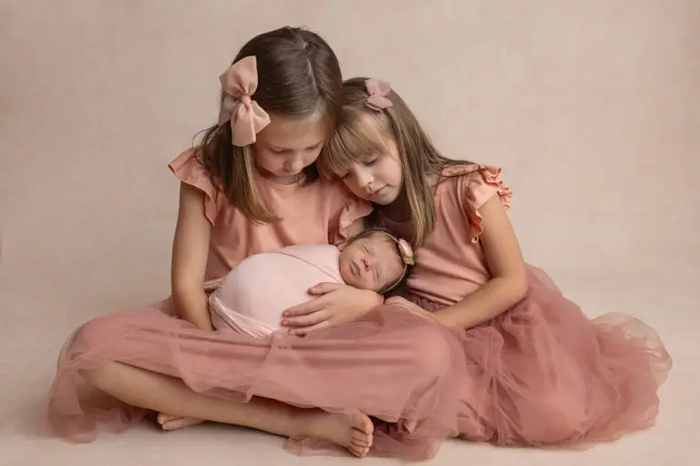 sisters wearing pink in a newborn photo session by Cream n Cocoa Photography in Cincinnati Ohio.