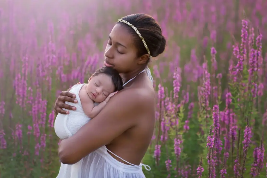 Mother and newborn in wildflower field at sunset – Cincinnati newborn photographer – Cream N Cocoa Cincinnati outdoor family photography — mother holding newborn in wildflower field at golden hour — Cream n Cocoa Photography