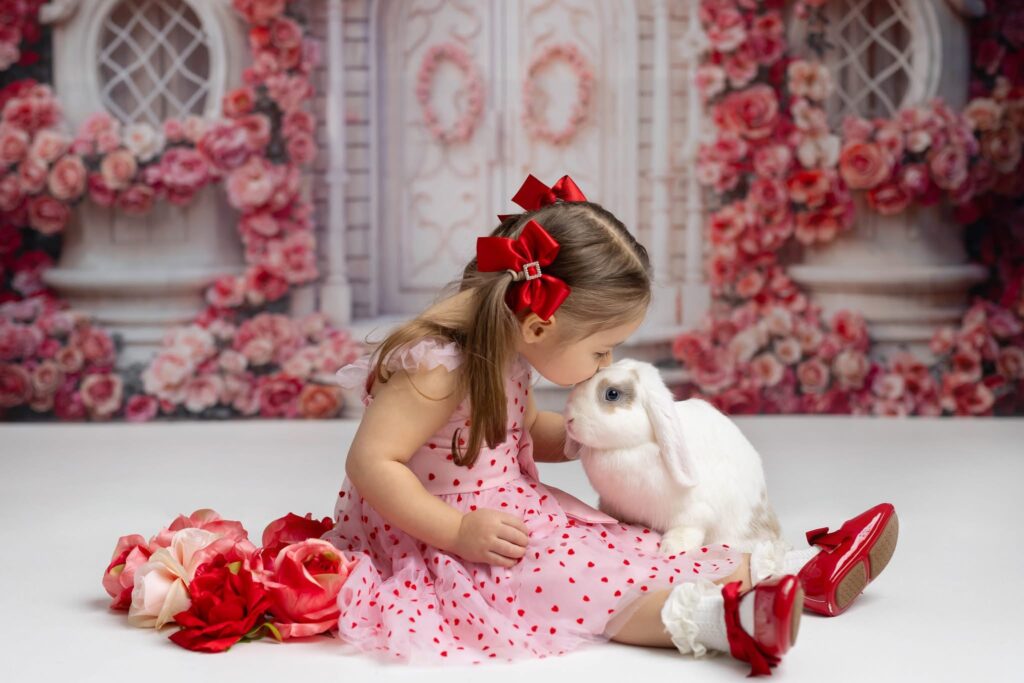 little girl with bunny – Cream N Cocoa Young girl gently interacting with a bunny during Valentine’s session with Cincinnati family photographer