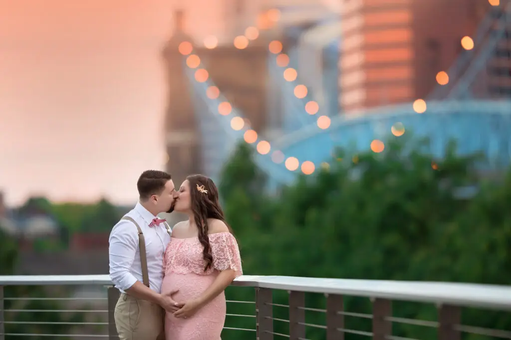Cincinnati couple photography session with city bridge lights in the background at dusk