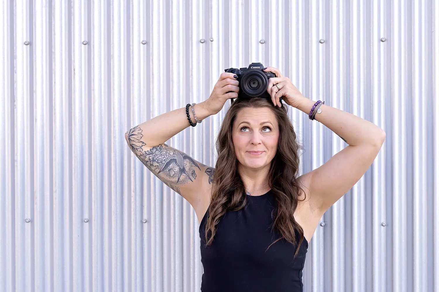 Professional personal branding portrait for Cream n Cocoa featuring a Cincinnati brand photographer holding a Canon camera against a modern textured backdrop. This image supports small business branding, website marketing, and visual storytelling for entrepreneurs in Cincinnati.
